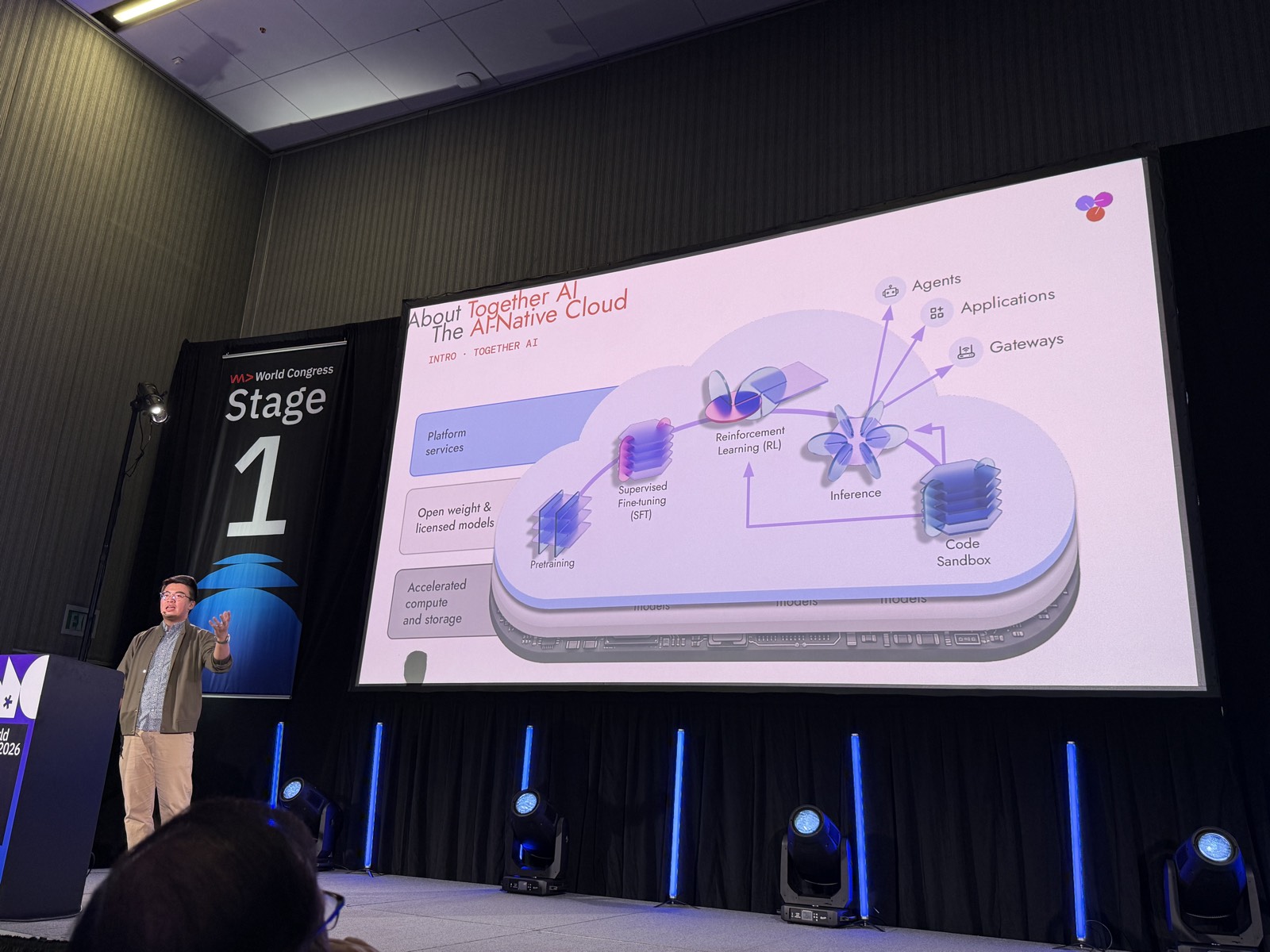 Dan Fu trên Stage 1 cạnh slide About Together AI: The AI-Native Cloud