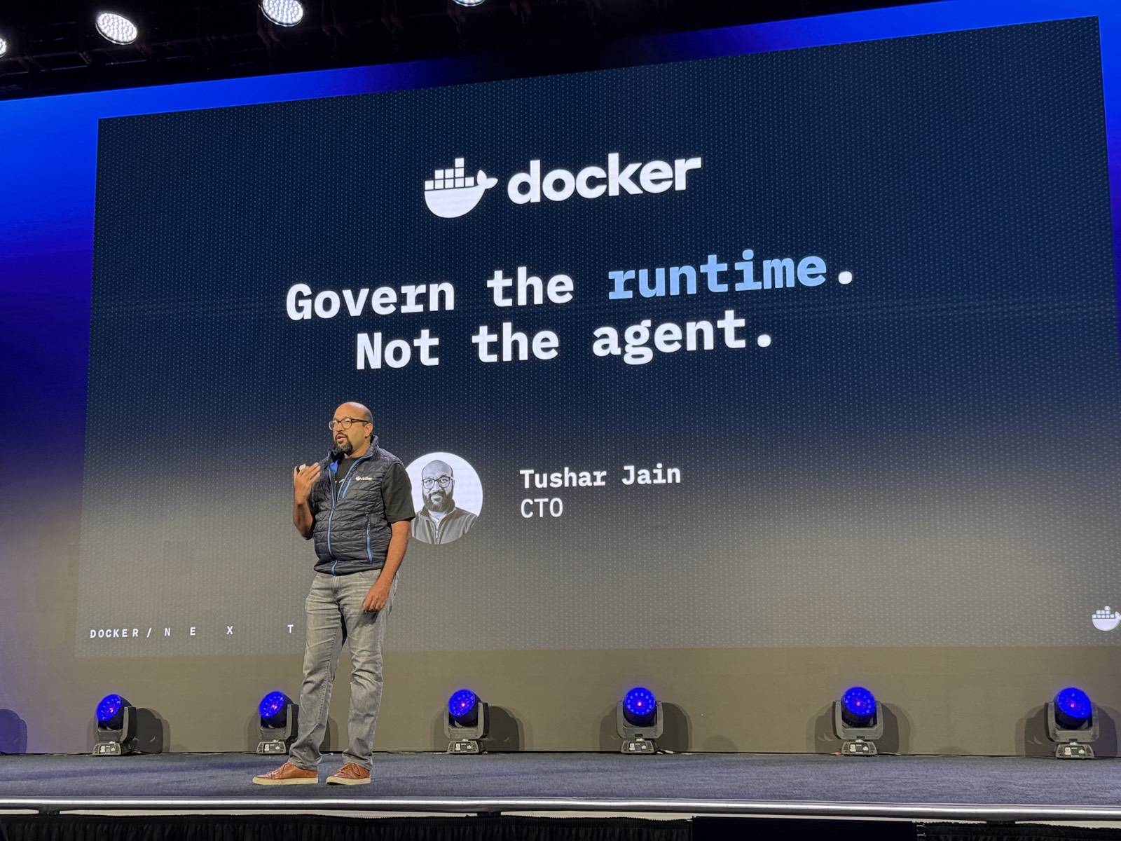 Tushar Jain trên sân khấu với slide Govern the runtime. Not the agent.